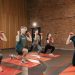 Indoor group workout session with dumbbells focusing on strength and fitness.